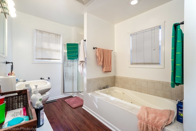 bathroom with sink, independent shower and bath, and hardwood / wood-style flooring