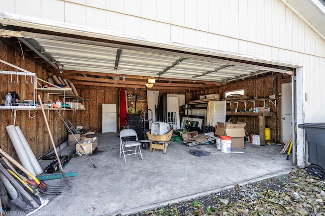 garage with white fridge and a garage door opener