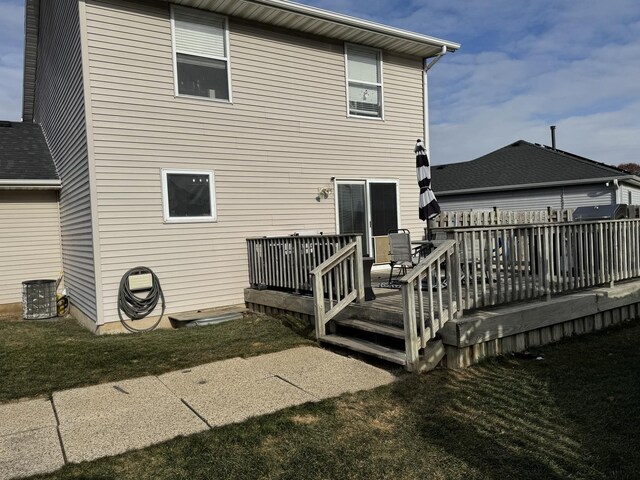 back of property featuring a yard and a deck