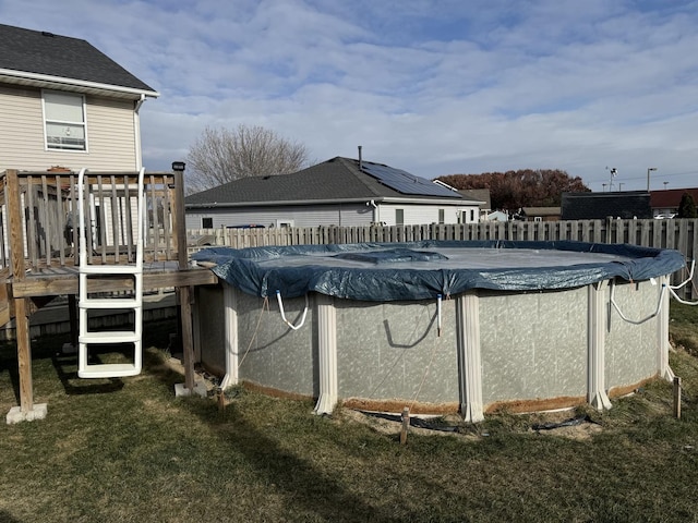 view of pool featuring a deck and a lawn