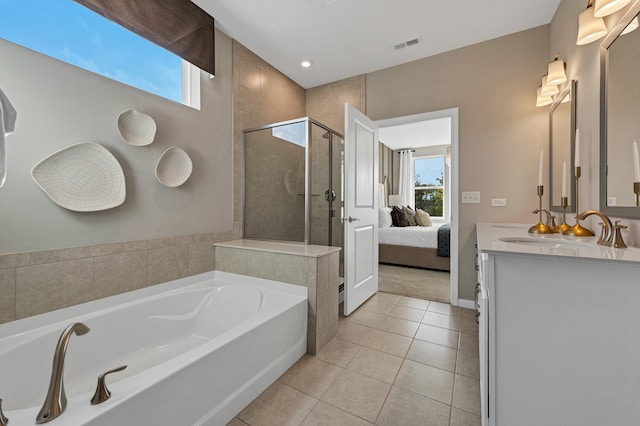 bathroom featuring tile patterned flooring, vanity, and plus walk in shower