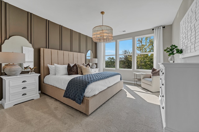 bedroom with light carpet and an inviting chandelier