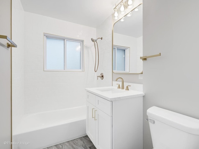 full bathroom with vanity, toilet, and tiled shower / bath combo