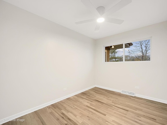 empty room with ceiling fan and light hardwood / wood-style floors