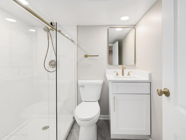 bathroom with vanity, an enclosed shower, and toilet