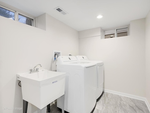 clothes washing area featuring sink and washing machine and dryer