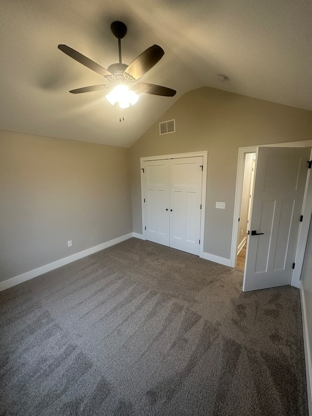 unfurnished bedroom with carpet flooring, ceiling fan, lofted ceiling, and a closet