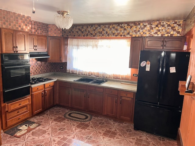 kitchen featuring black appliances, sink, tile patterned floors, and tasteful backsplash