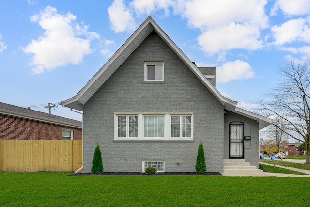 back of house with a lawn