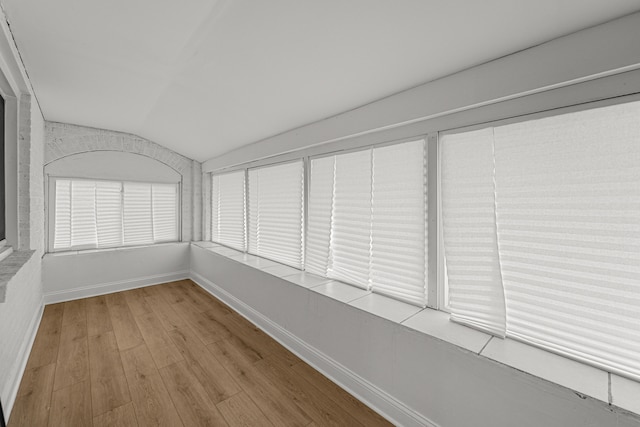 unfurnished sunroom with lofted ceiling