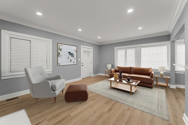 living room with light wood-type flooring and ornamental molding