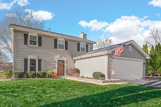 view of front of house featuring a garage and a front lawn