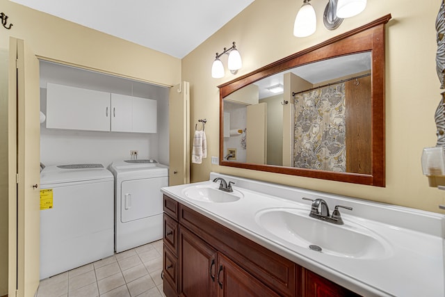 bathroom featuring tile patterned flooring, vanity, and separate washer and dryer