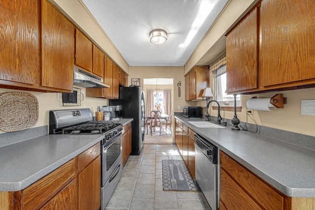 kitchen with sink, light tile patterned floors, and stainless steel appliances