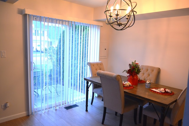 dining area featuring a chandelier and hardwood / wood-style floors