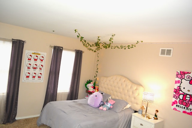 bedroom featuring carpet flooring and multiple windows