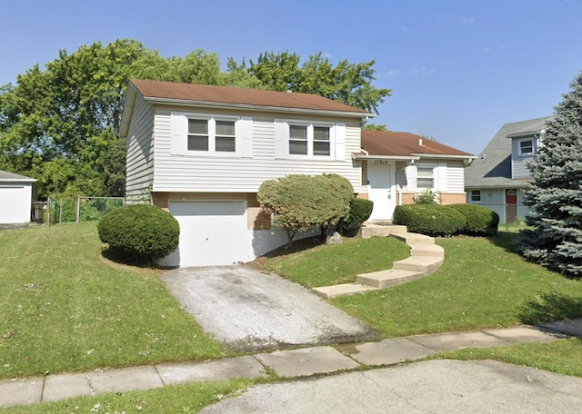 view of front of house featuring a garage and a front lawn