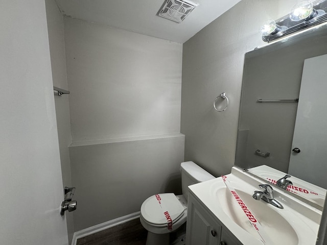 bathroom featuring hardwood / wood-style floors, vanity, and toilet