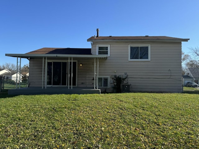 rear view of house with a lawn