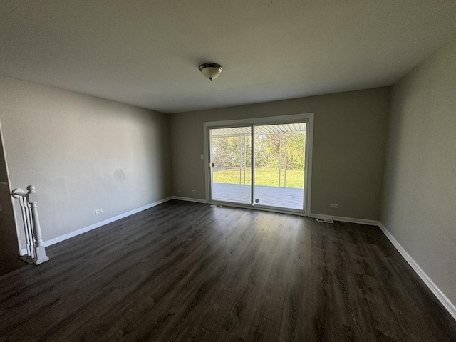 empty room with dark hardwood / wood-style flooring