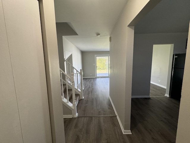 corridor with dark hardwood / wood-style floors