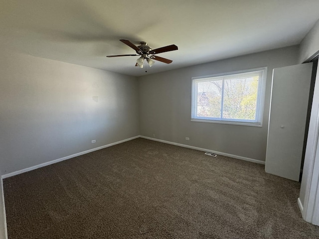 carpeted spare room with ceiling fan