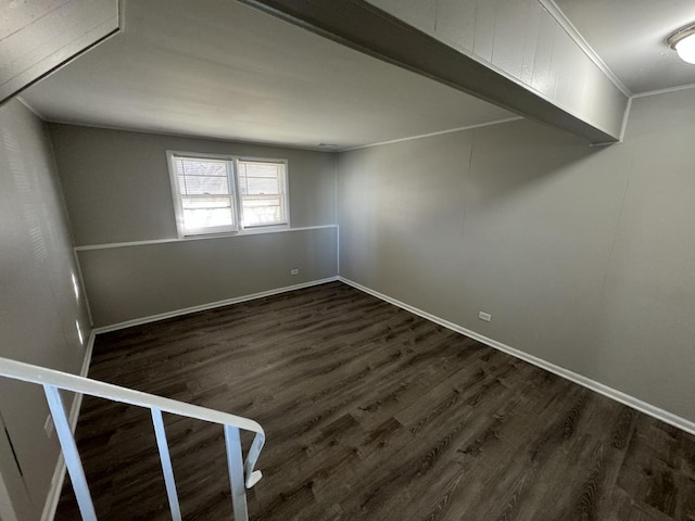 spare room featuring dark hardwood / wood-style floors and crown molding