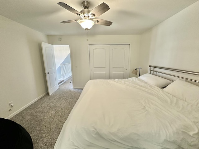 carpeted bedroom featuring ceiling fan and a closet