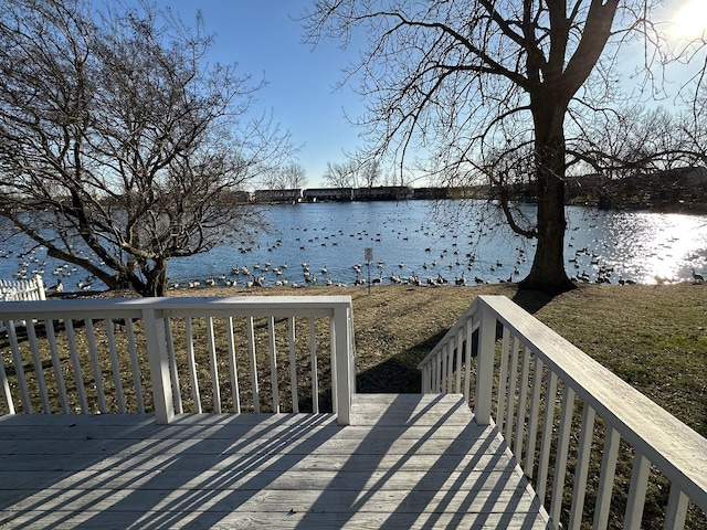 wooden terrace featuring a water view