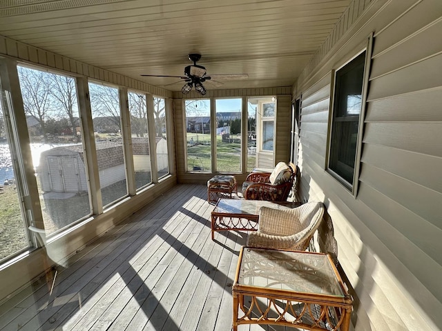 sunroom / solarium featuring ceiling fan