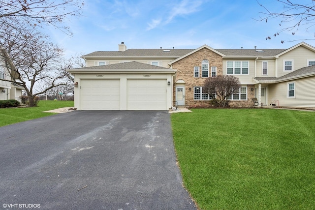 view of front of property featuring a garage and a front lawn