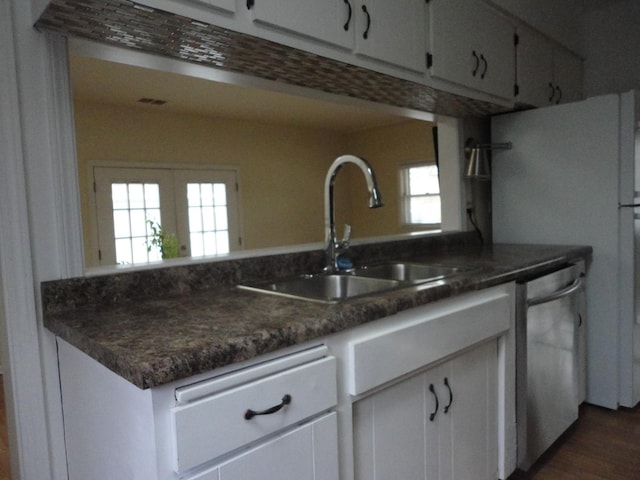 kitchen with french doors, sink, dishwasher, white cabinetry, and fridge