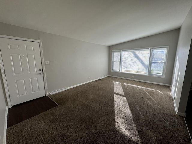 interior space featuring vaulted ceiling and baseboard heating