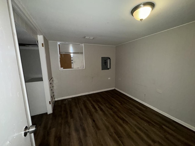 basement with electric panel and dark hardwood / wood-style flooring