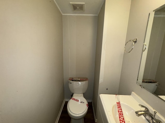 bathroom featuring vanity and toilet