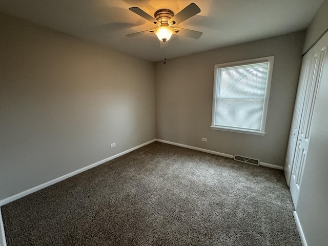 carpeted empty room with ceiling fan