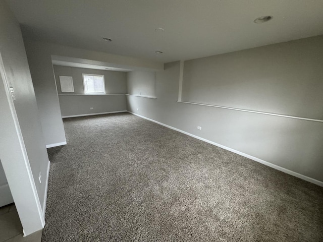 spare room with dark colored carpet