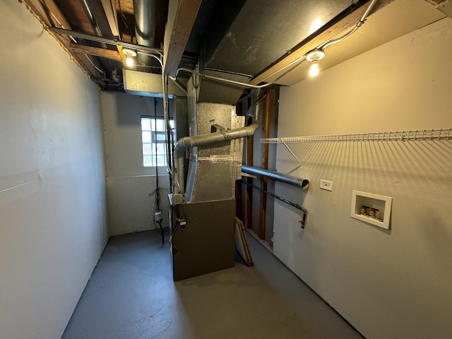 utility room featuring heating unit