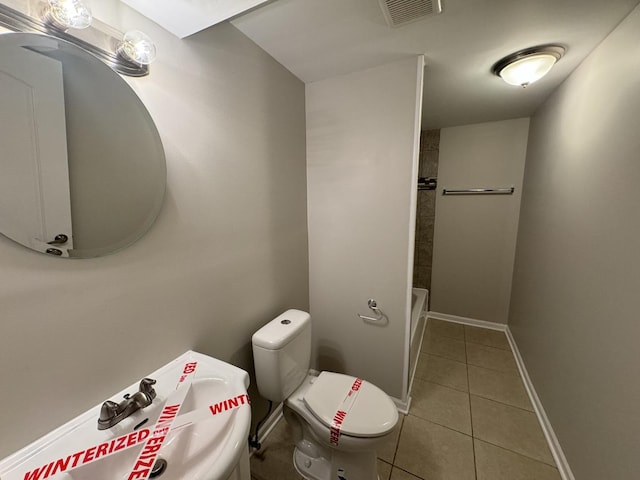 bathroom featuring tile patterned flooring and toilet