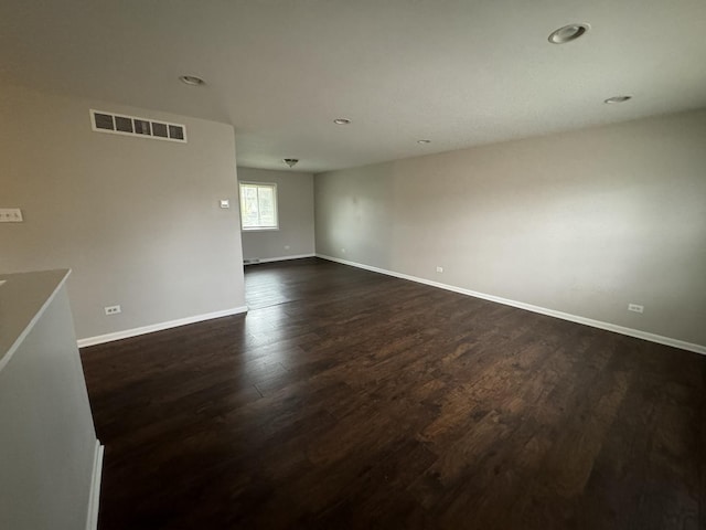 empty room with dark hardwood / wood-style floors