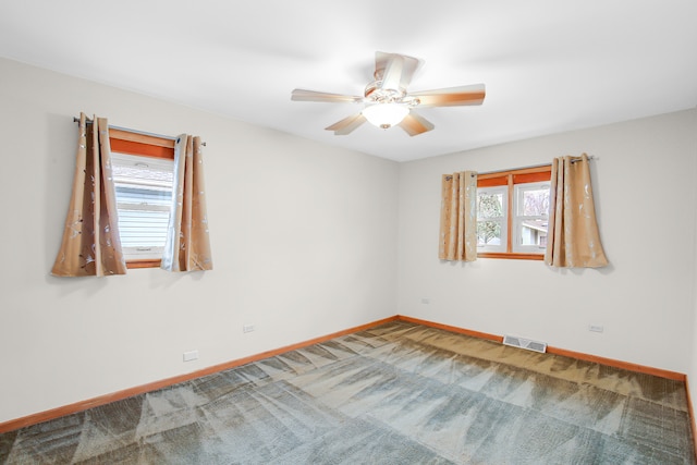 unfurnished room with carpet floors and ceiling fan