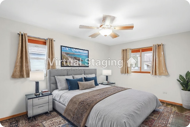 bedroom with ceiling fan and dark wood-type flooring