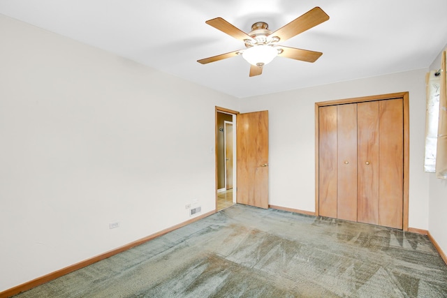 unfurnished bedroom featuring a closet, light colored carpet, and ceiling fan