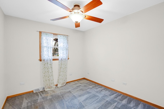 carpeted spare room with ceiling fan