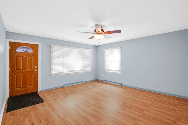 foyer entrance with ceiling fan and light hardwood / wood-style floors