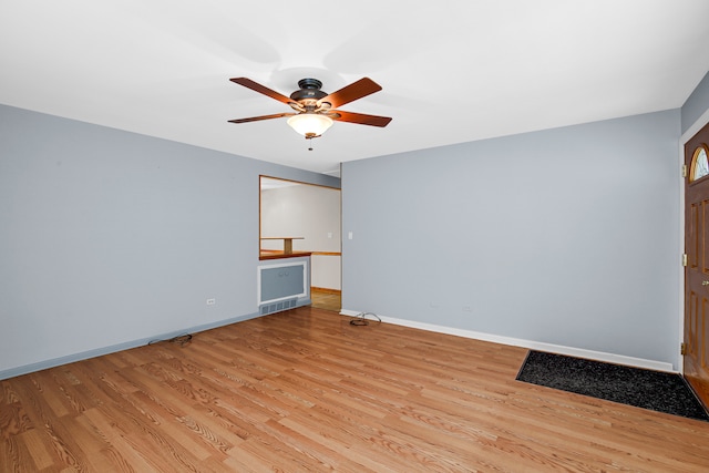 spare room featuring ceiling fan and light hardwood / wood-style flooring