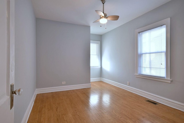 spare room with ceiling fan, plenty of natural light, and light hardwood / wood-style floors