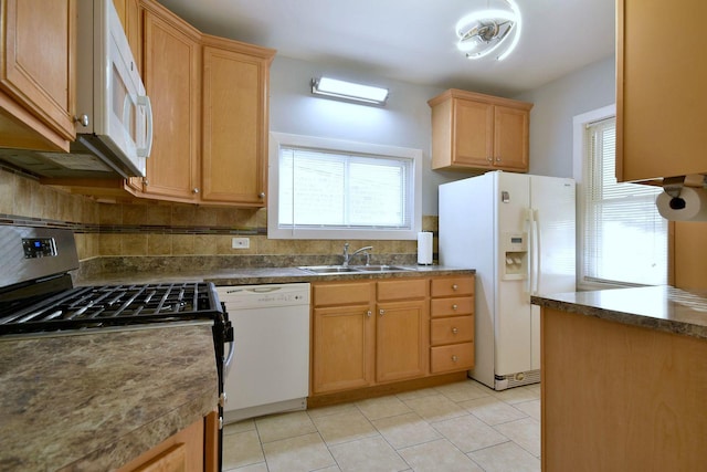 kitchen featuring light tile patterned floors, white appliances, backsplash, and sink