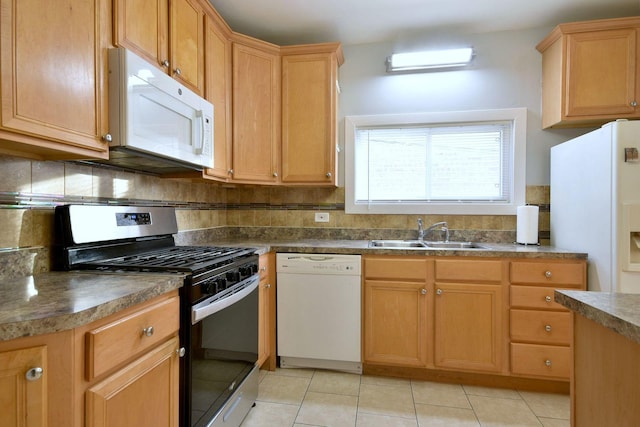 kitchen with light tile patterned flooring, white appliances, backsplash, and sink