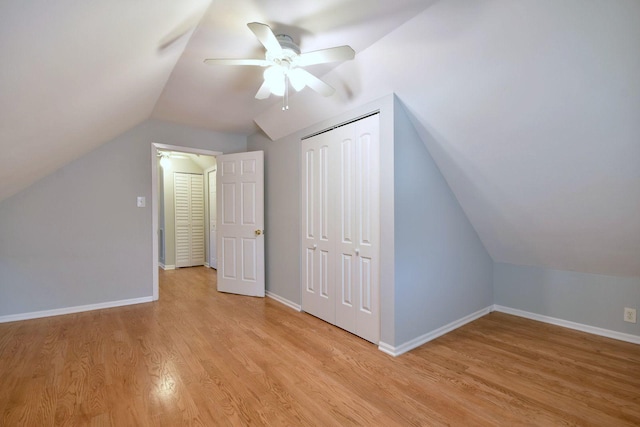 additional living space with light hardwood / wood-style floors, vaulted ceiling, and ceiling fan